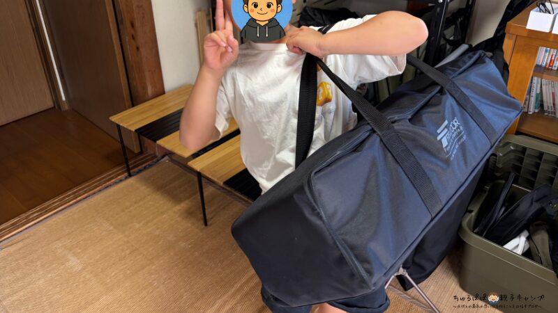 FIELDOORアルミパネルテーブル135を小学生の子どもが持っている様子